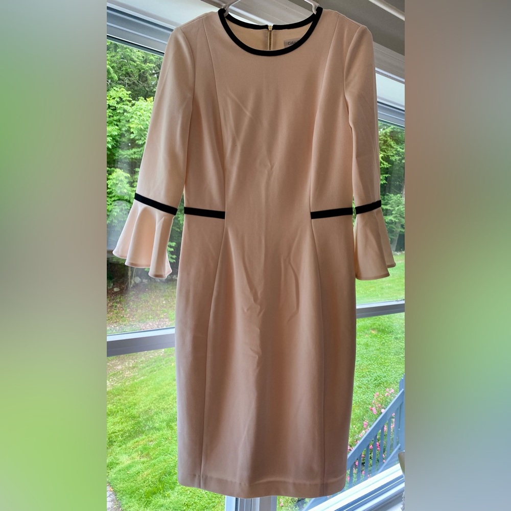 Calvin Klein size 6 peach 3/4 sleeve dress with black trim detail.